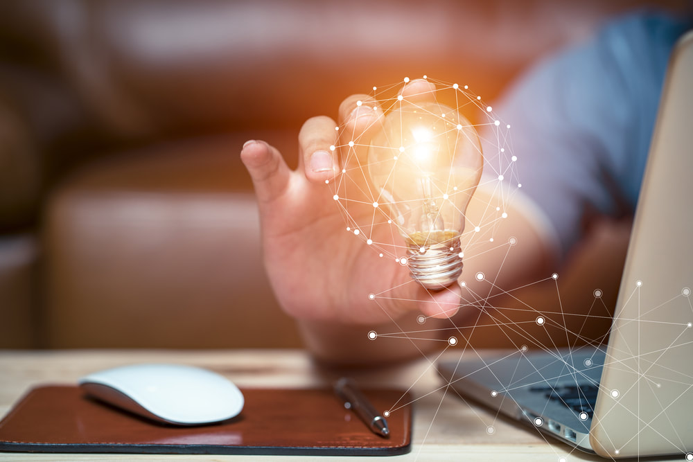 Hand holding a lightbulb. Innovation in business header image.